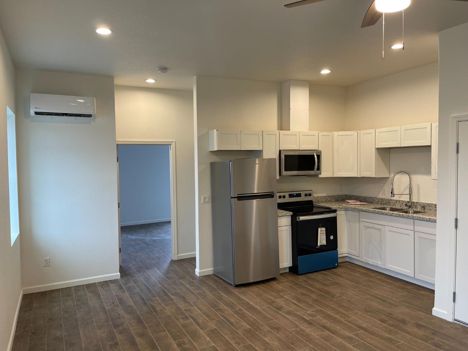217 5th Street, Unit A Colusa, CA 95932 - Photo 1 of 6 a kitchen with stainless steel appliances granite countertop a refrigerator stove and oven