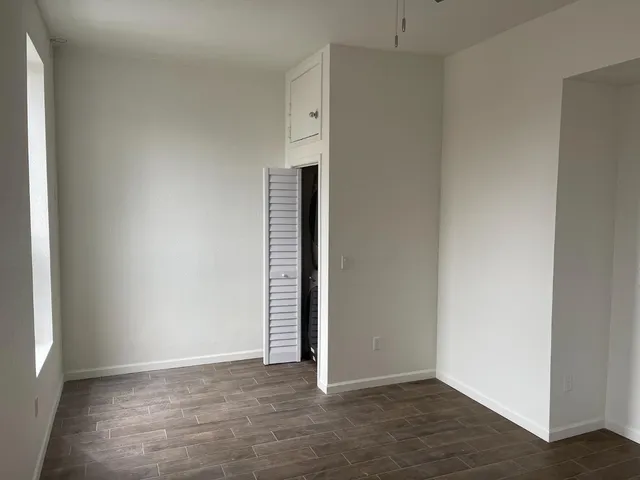 an empty room with wooden floor