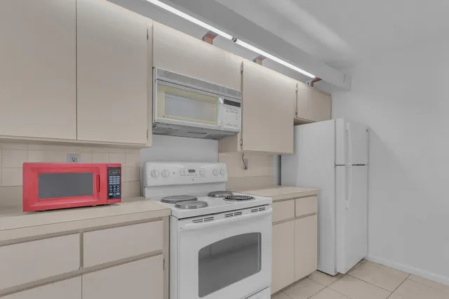 a kitchen with stainless steel appliances a white cabinet and a refrigerator