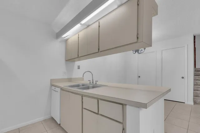 a kitchen with cabinets a washer and dryer