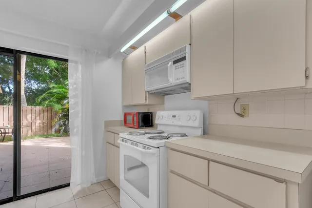 a kitchen with a sink and large window