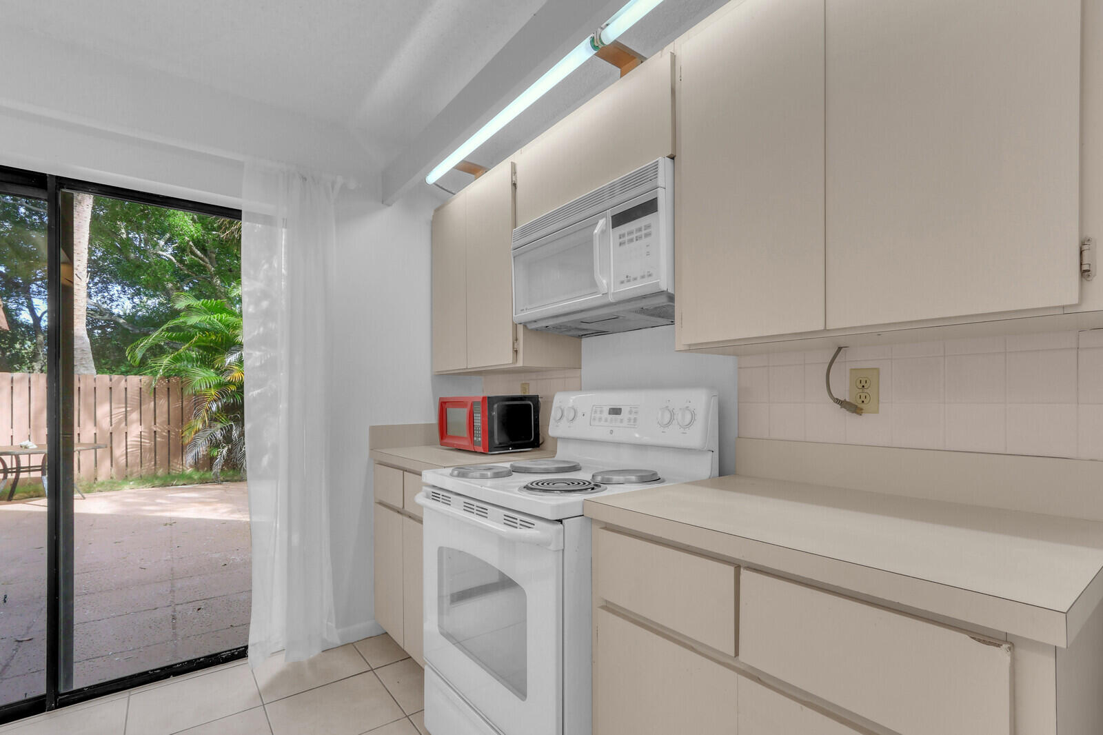 3061 30th Court Jupiter, FL 33477 - Photo 15 of 40 a kitchen with cabinets a washer and dryer