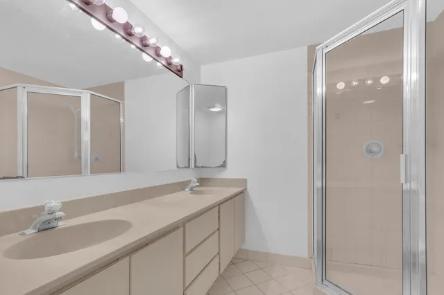 a bathroom with a glass shower door