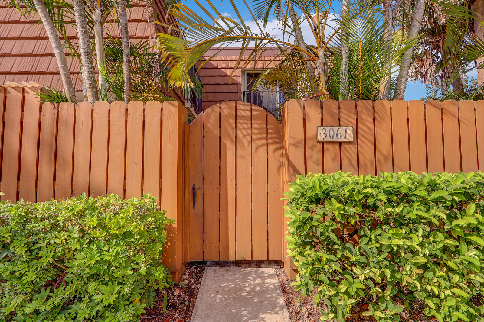 3061 30th Court Jupiter, FL 33477 - Photo 4 of 40 a view of a backyard with potted plants