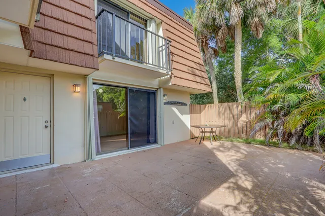 a view of the house with backyard and sitting area
