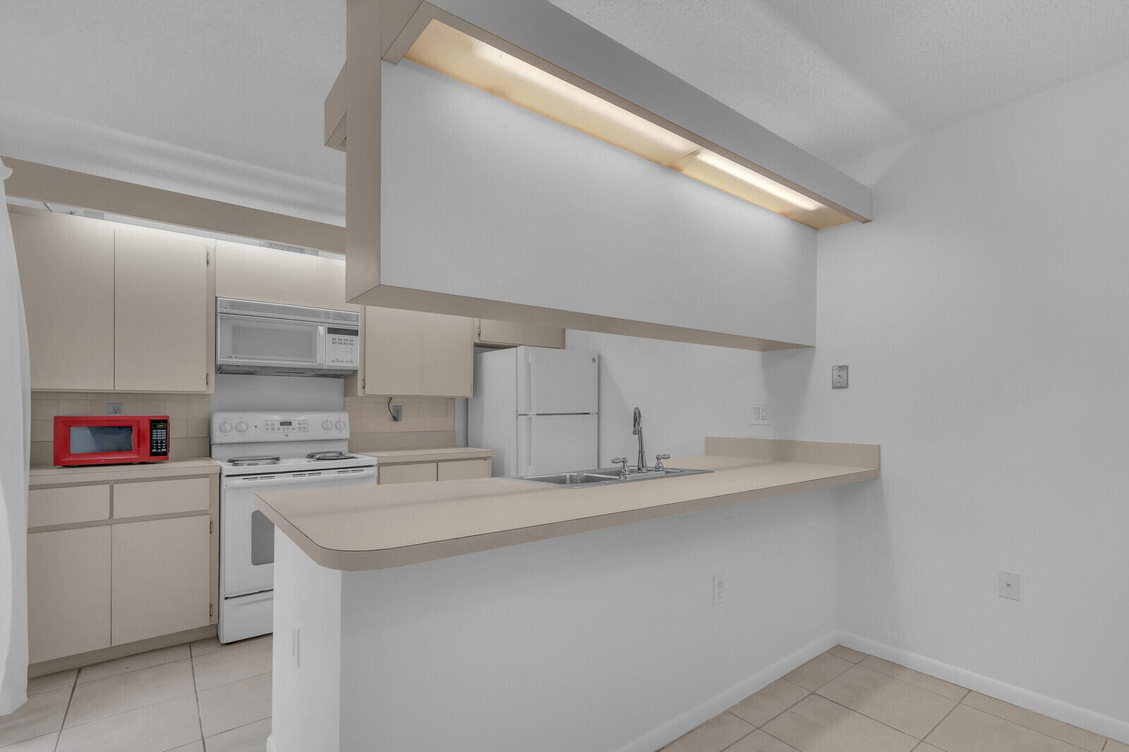 3061 30th Court Jupiter, FL 33477 - Photo 10 of 40 a kitchen with stainless steel appliances granite countertop a sink and cabinets