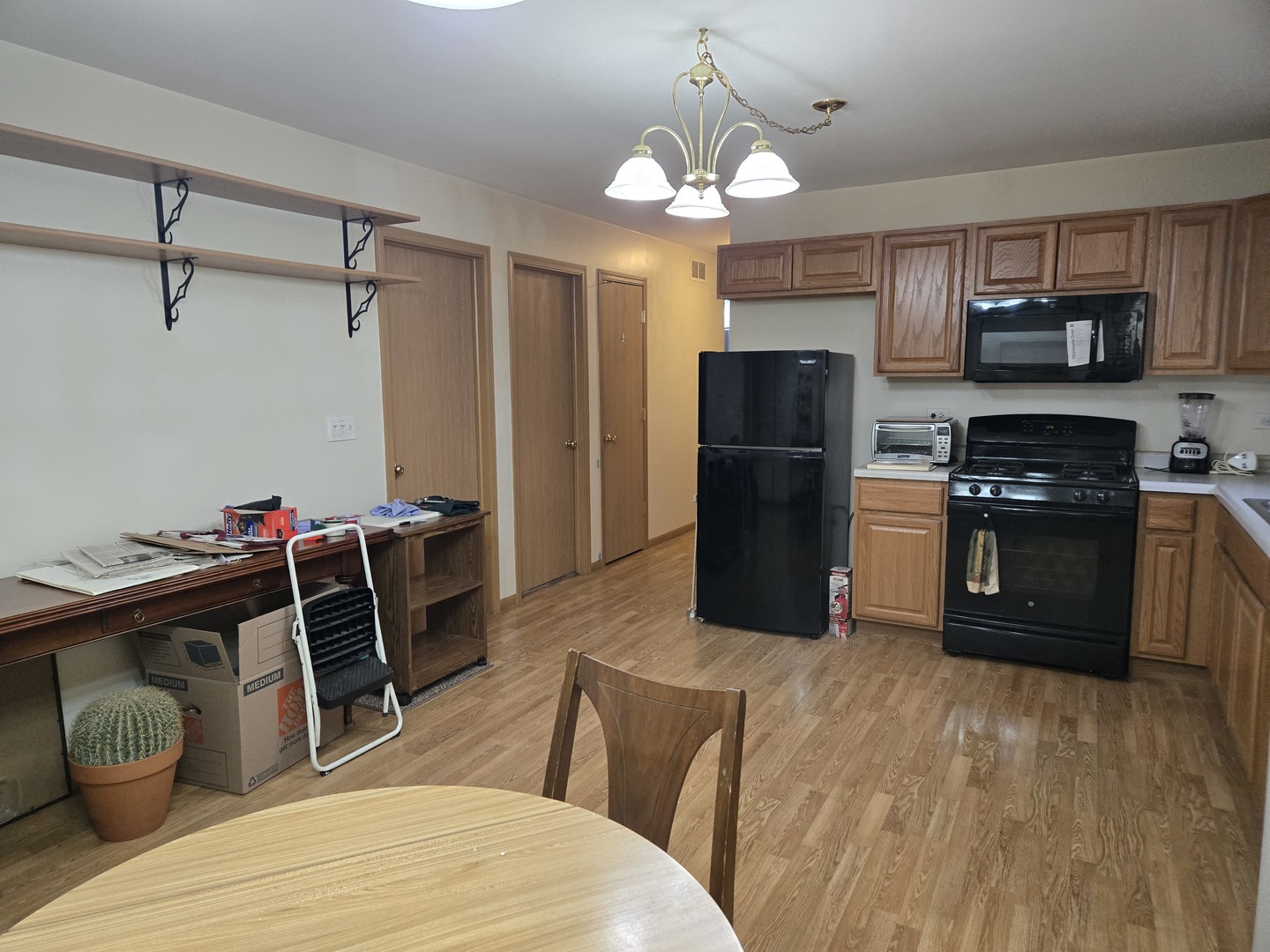 3117 Carpenter Street Steger, IL 60475 - Photo 8 of 20 a kitchen with stainless steel appliances granite countertop a refrigerator a stove a sink dishwasher and a dining table with wooden floor