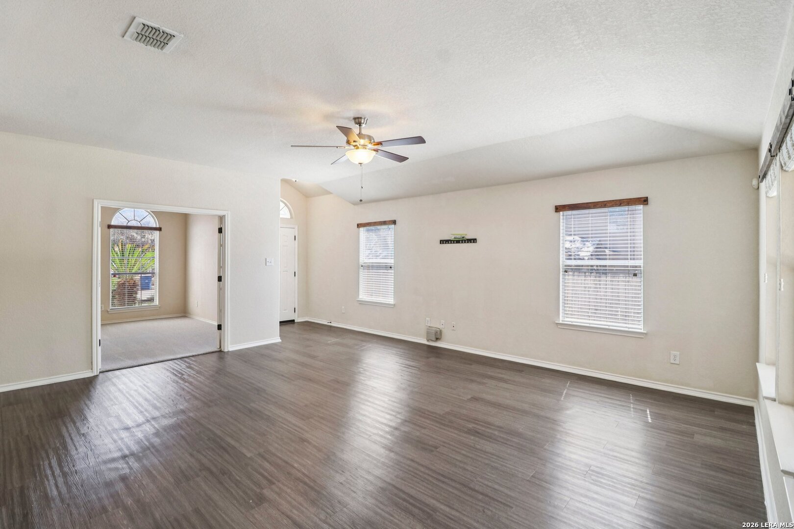10723 Kobort Helotes, TX 78023 - Photo 12 of 36 a view of an empty room with a window and wooden floor