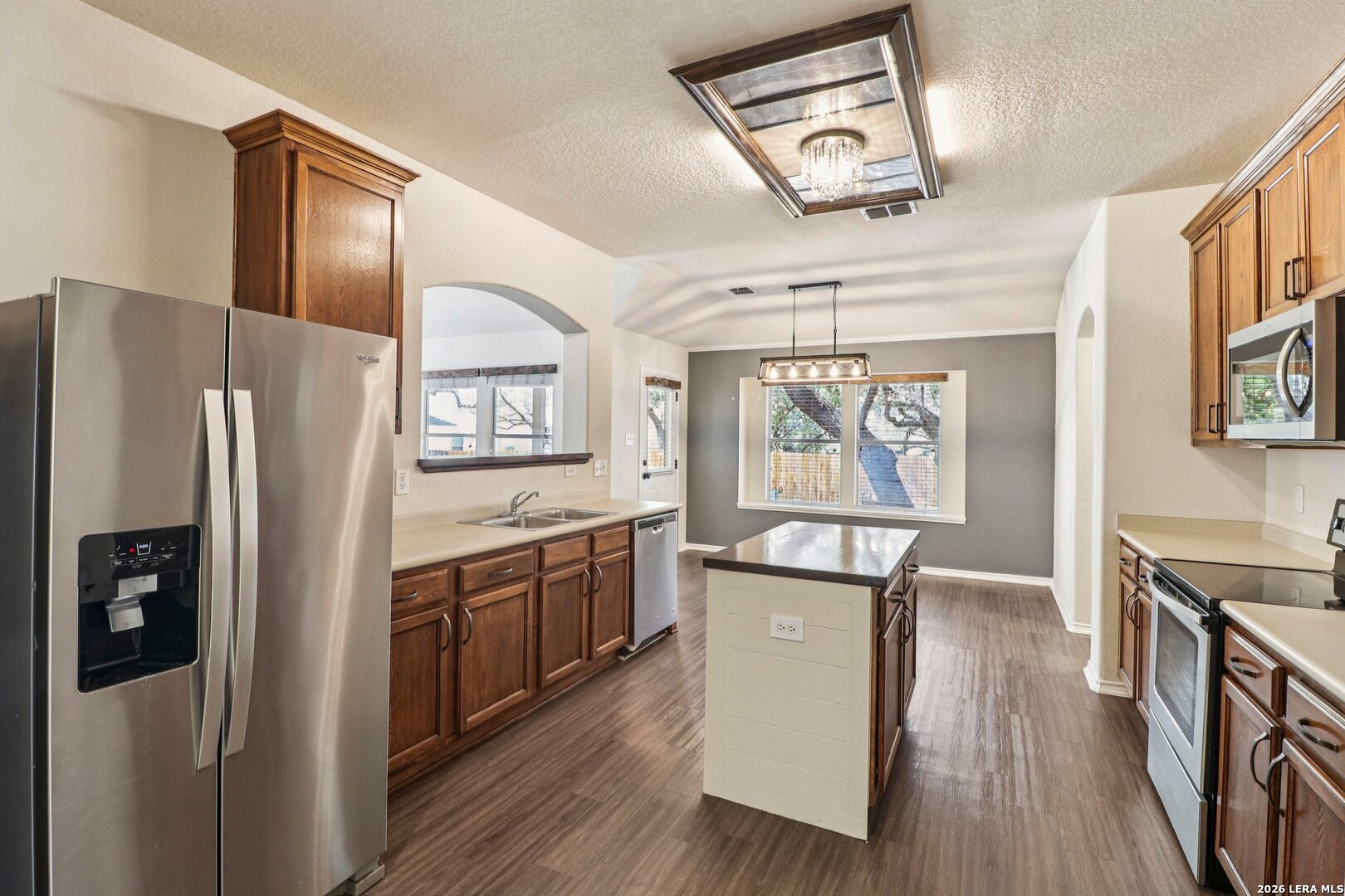10723 Kobort Helotes, TX 78023 - Photo 14 of 36 a kitchen with stainless steel appliances granite countertop a refrigerator and a stove top oven