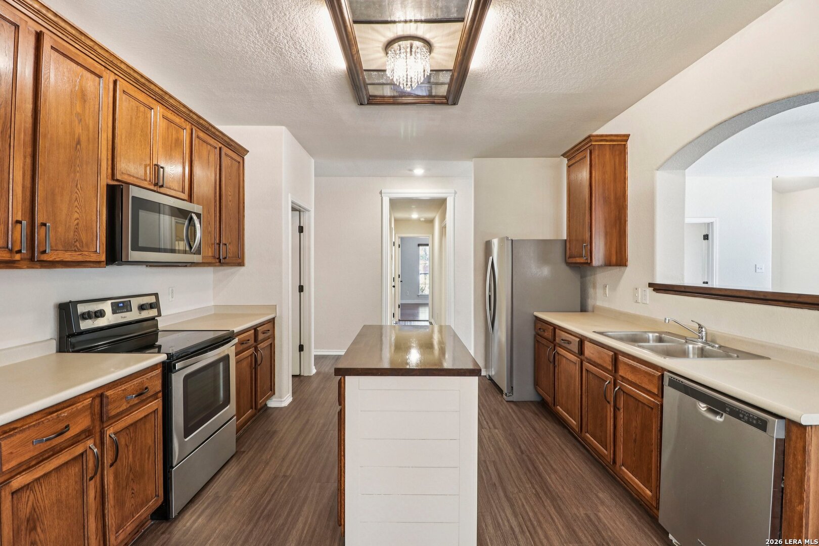 10723 Kobort Helotes, TX 78023 - Photo 15 of 36 a kitchen with stainless steel appliances granite countertop a stove a sink and a refrigerator