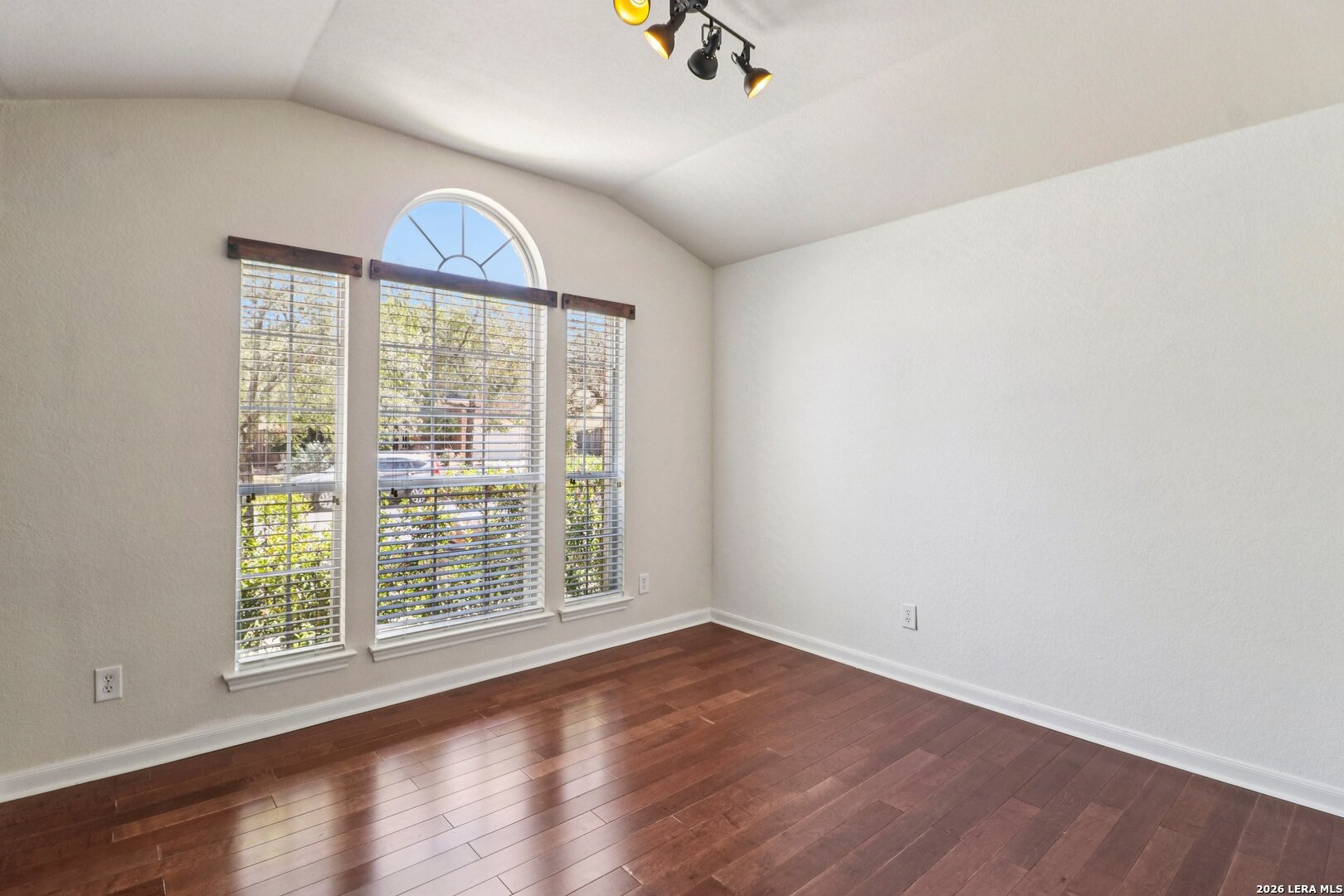 10723 Kobort Helotes, TX 78023 - Photo 18 of 36 an empty room with wooden floor and a window