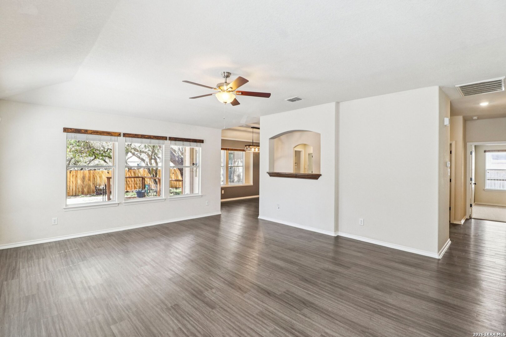 10723 Kobort Helotes, TX 78023 - Photo 2 of 36 a view of an empty room with window and wooden floor