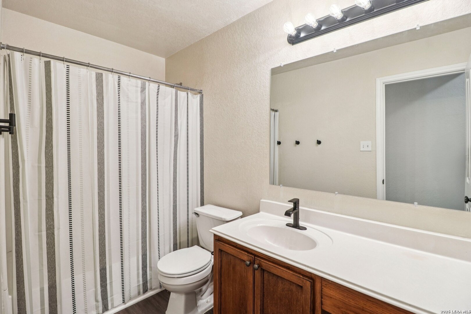 10723 Kobort Helotes, TX 78023 - Photo 26 of 36 a bathroom with a sink a toilet and a mirror