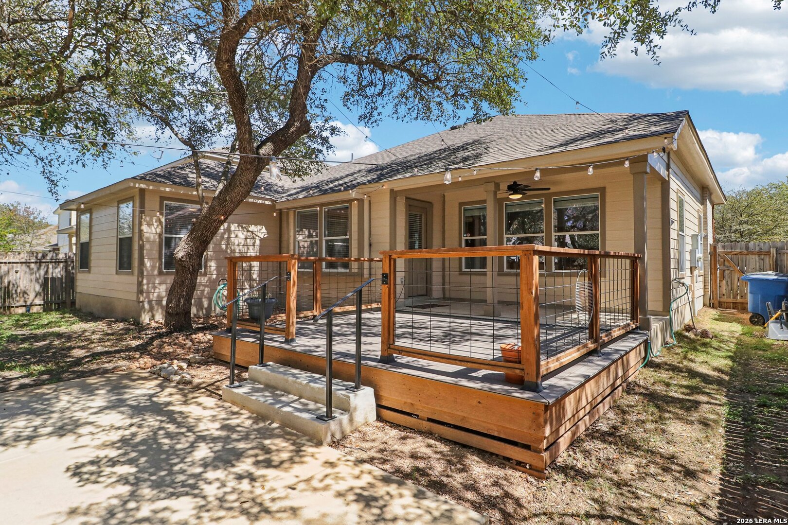 10723 Kobort Helotes, TX 78023 - Photo 31 of 36 a view of a house with a large tree and wooden fence