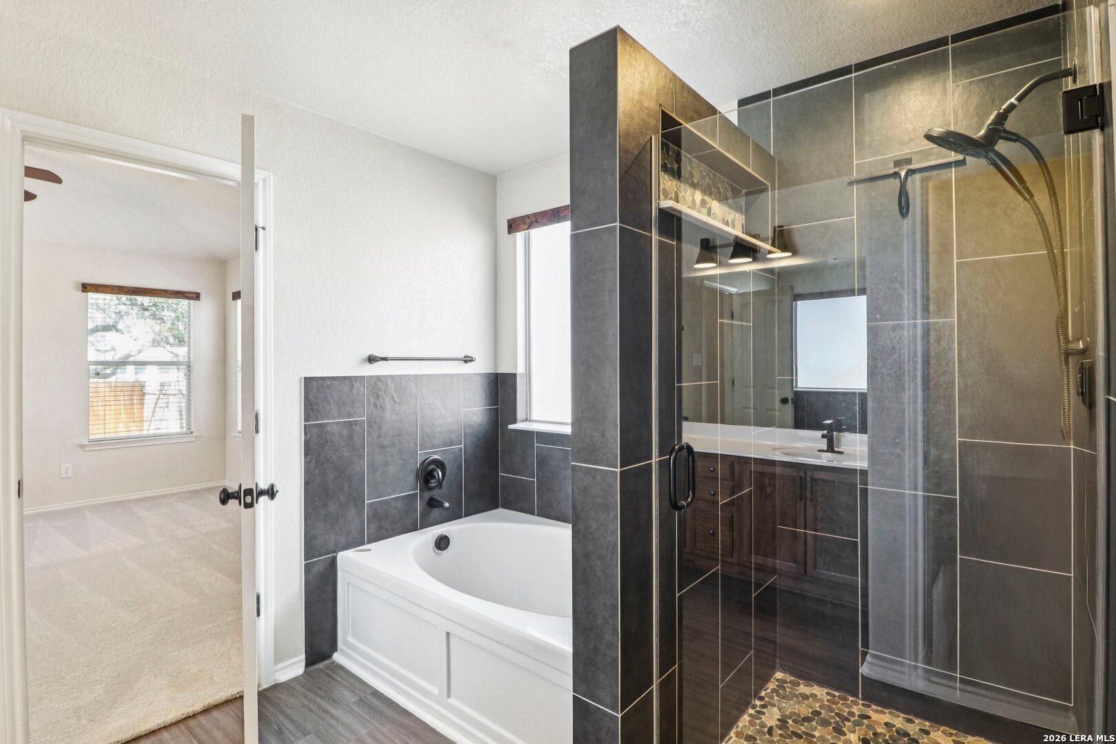 10723 Kobort Helotes, TX 78023 - Photo 4 of 36 a bathroom with a tub a sink and a shower