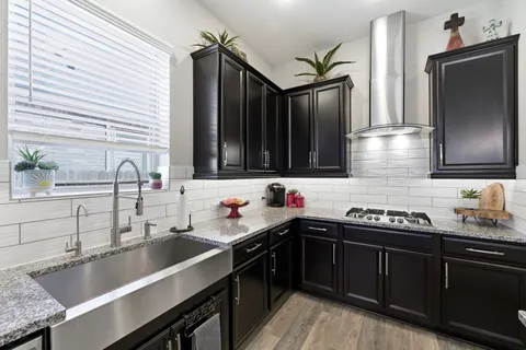 a kitchen with a sink and stove