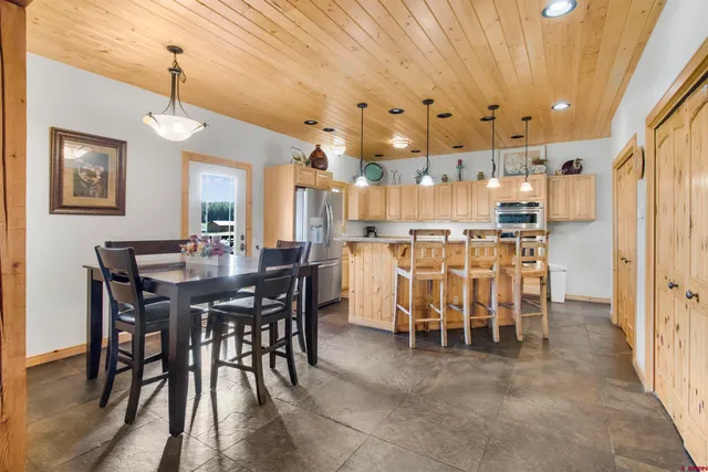 a view of a dining room with furniture and chandelier