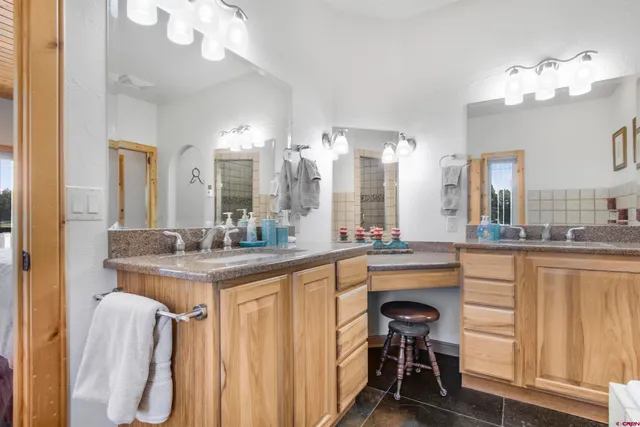 a kitchen with a table chairs sink and cabinets