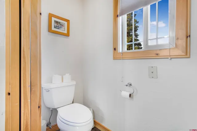 a white toilet sitting next to a bathroom sink