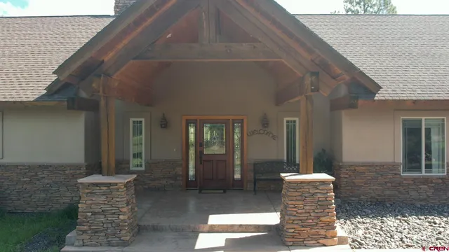 a front view of a house with outdoor seating