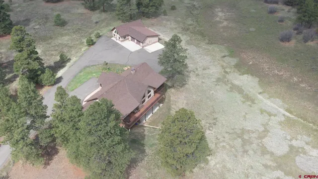 an aerial view of a house with a yard