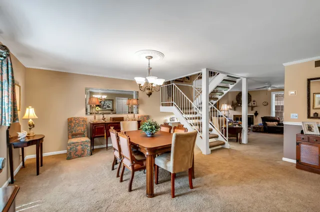 a view of a dining room with furniture and a chandelier