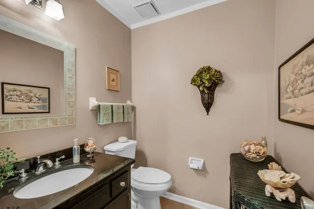 a bathroom with a sink mirror and toilet