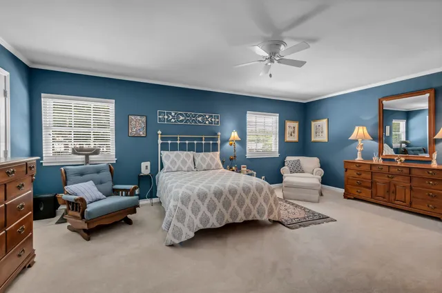 a bedroom with furniture and a large window