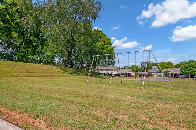 a view of a house with yard and tree s