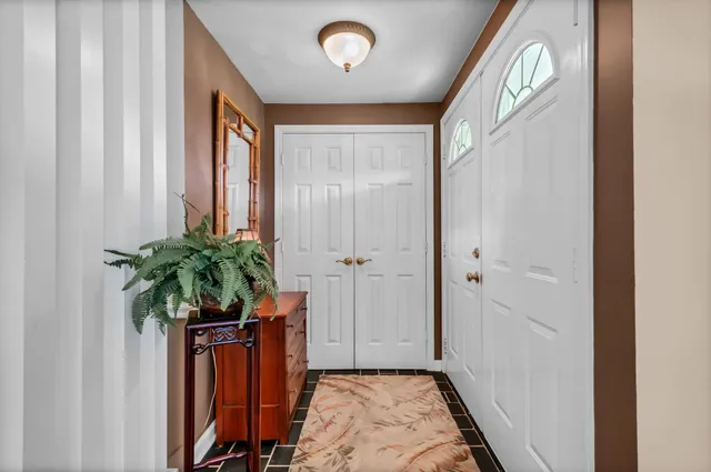 a entryway with a potted plant on a dresser