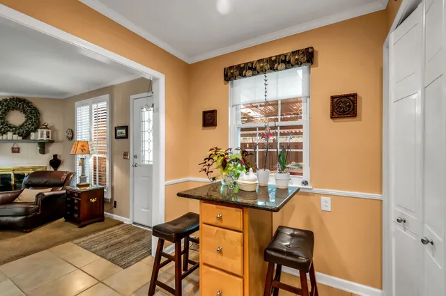 a dining room with furniture and a window