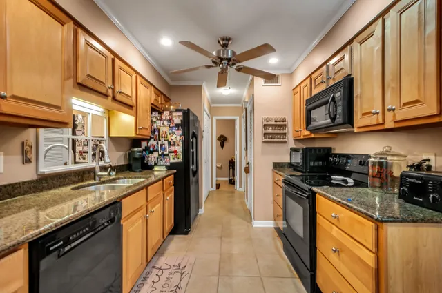 a kitchen with stainless steel appliances granite countertop a sink stove and cabinets