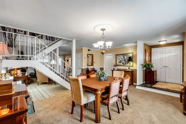 a dining room with furniture and chandelier