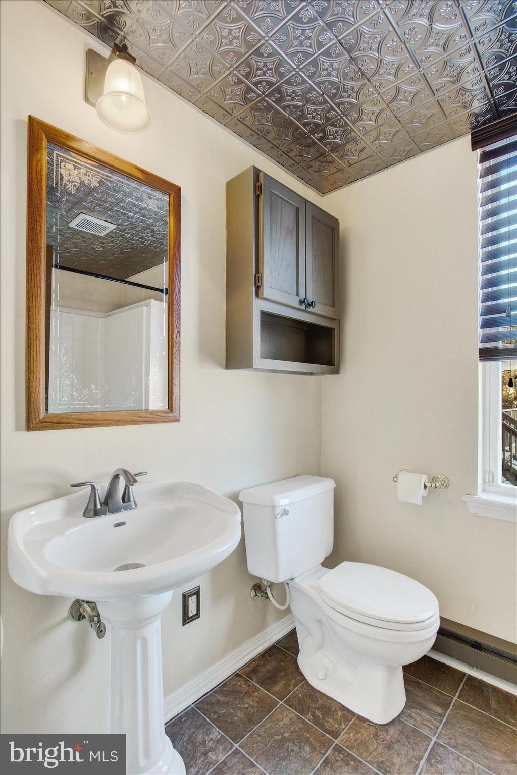 564 Blooming Grove Road Hanover, PA 17331 - Photo 14 of 27 a bathroom with a toilet a sink and mirror