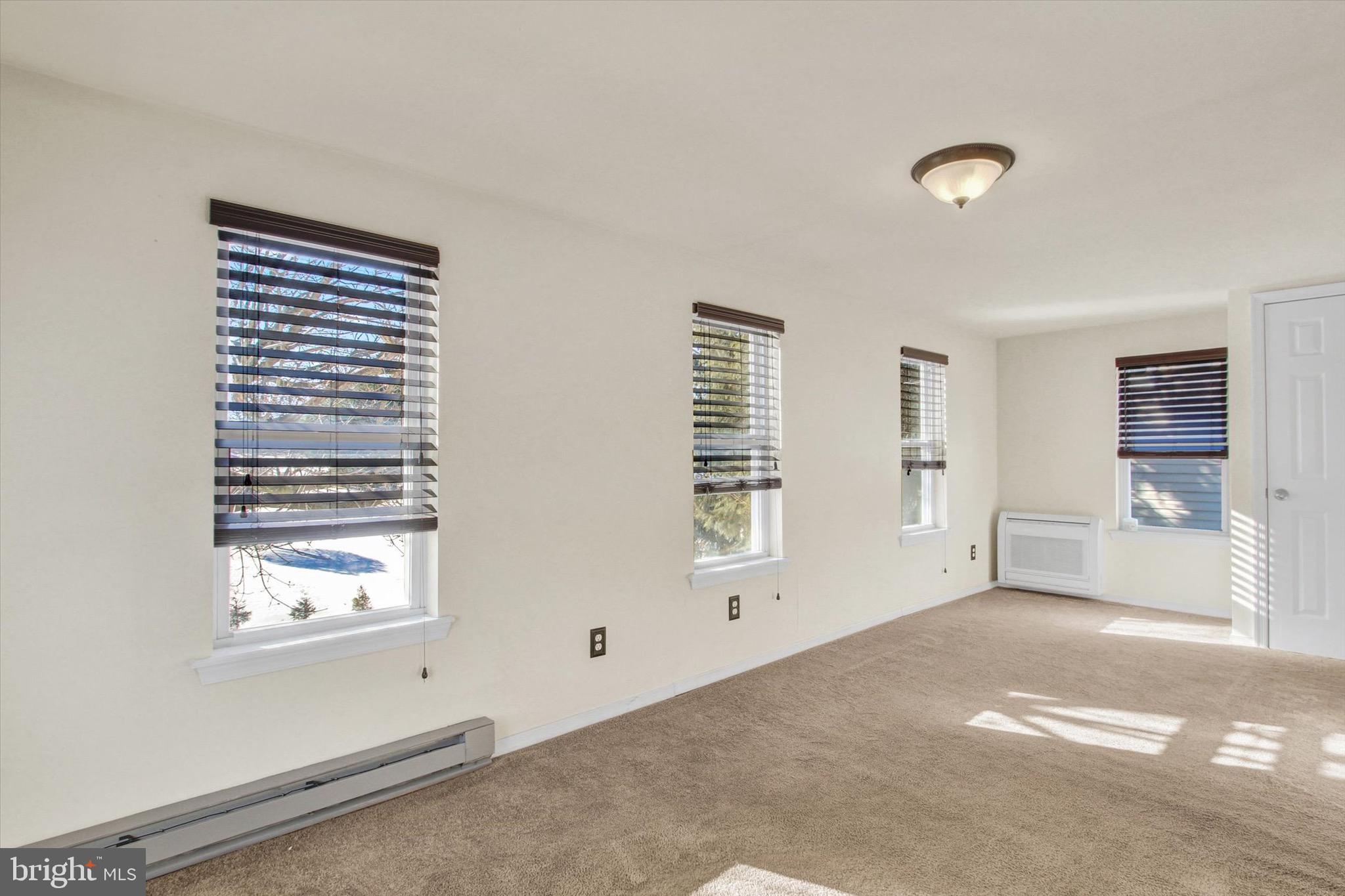 564 Blooming Grove Road Hanover, PA 17331 - Photo 16 of 27 a view of an empty room with a window and a ceiling fan