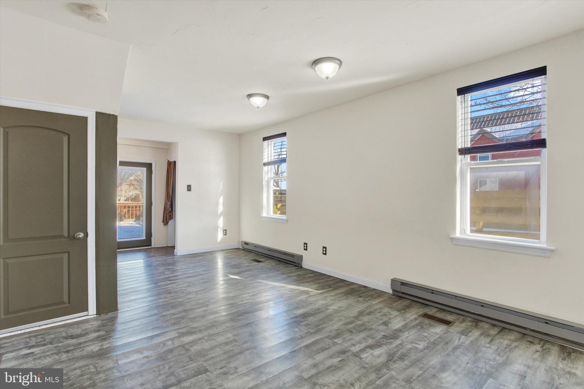 564 Blooming Grove Road Hanover, PA 17331 - Photo 4 of 27 an empty room with wooden floor and a window