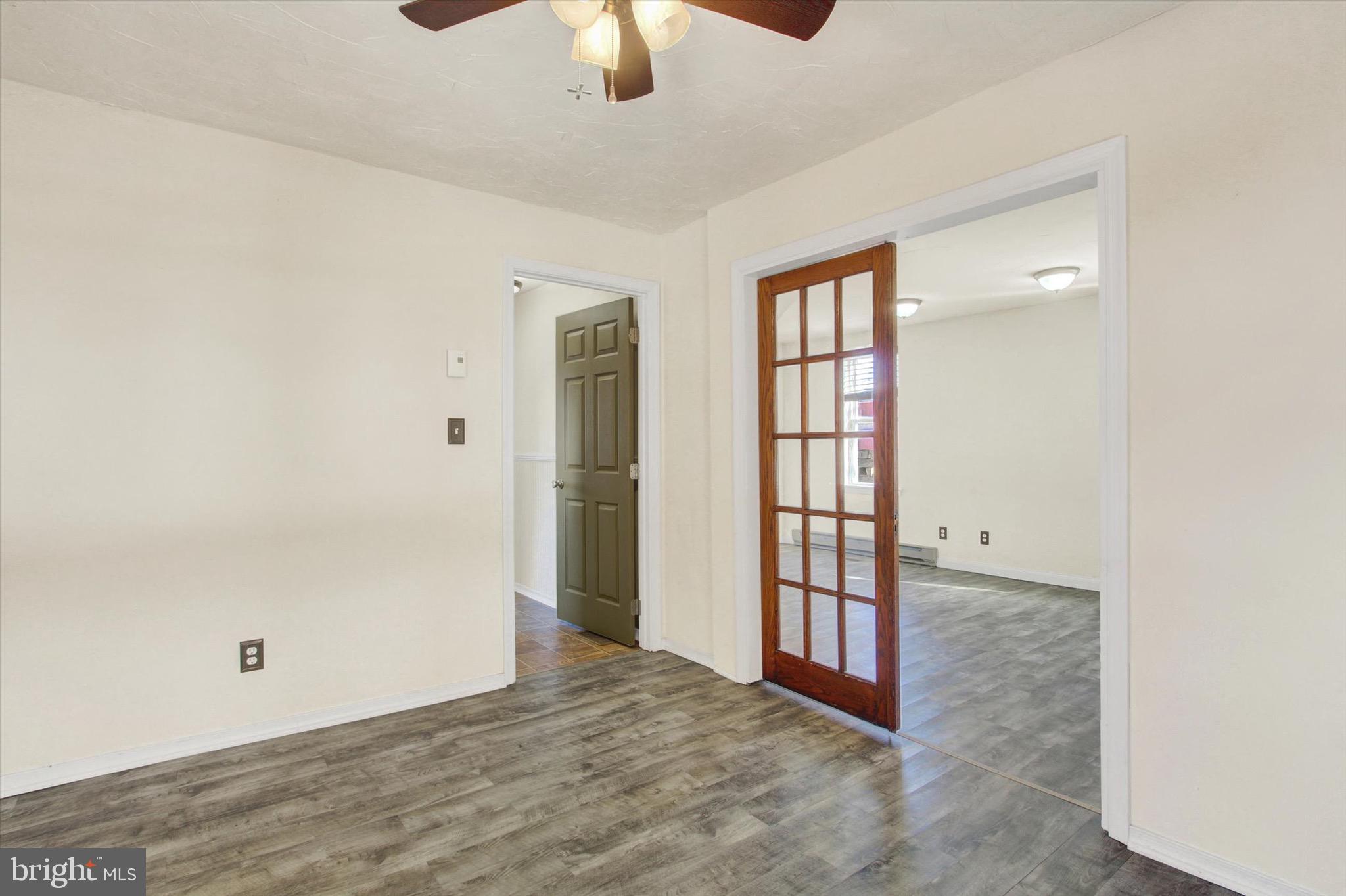 564 Blooming Grove Road Hanover, PA 17331 - Photo 8 of 27 an empty room with chandelier fan and windows