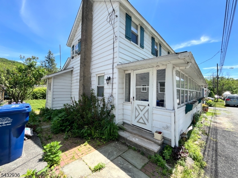 9 New Row Road, Unit A Hibernia, NJ 07842 - Photo 2 of 18 a view of a white house with a yard and potted plants