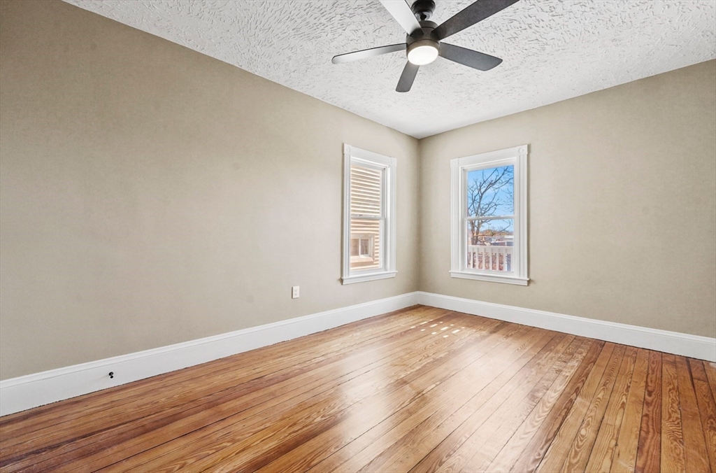 18 Lyon Street, Unit 2 Boston, MA 02122 - Photo 15 of 23 a view of an empty room with wooden floor and a window