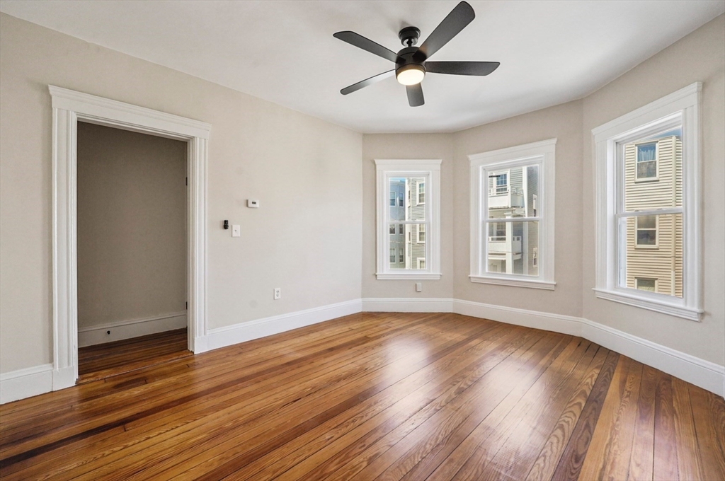 18 Lyon Street, Unit 2 Boston, MA 02122 - Photo 7 of 23 a view of empty room with wooden floor and fan