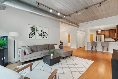 a living room with furniture and wooden floor