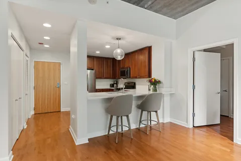 a kitchen with a sink cabinets and wooden floor
