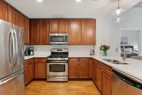 a kitchen with a sink stove and refrigerator