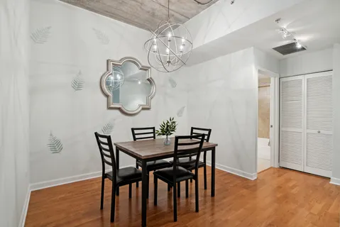 a view of a dining room with furniture and chandelier