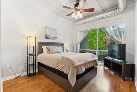 a large bed sitting in a bedroom next to a window