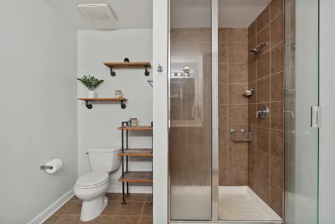 a bathroom with a toilet and a shower