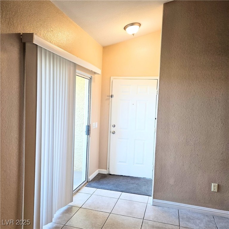 2120 Ramrod Avenue, Unit 1226 Henderson, NV 89014 - Photo 11 of 53 Doorway featuring a textured wall and light tile patterned floors