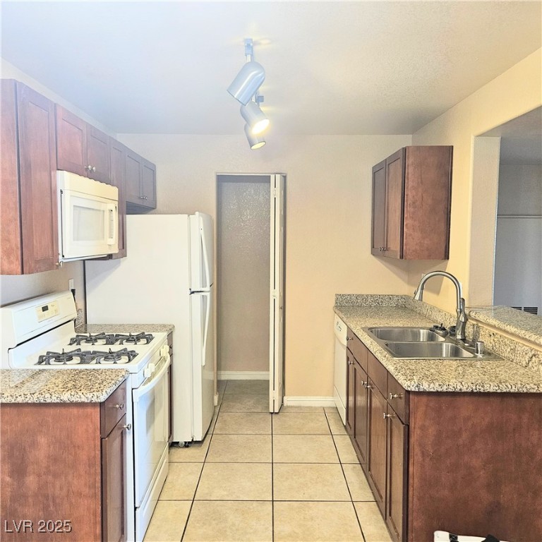 2120 Ramrod Avenue, Unit 1226 Henderson, NV 89014 - Photo 18 of 53 Kitchen with white appliances, light tile patterned floors, and a peninsula