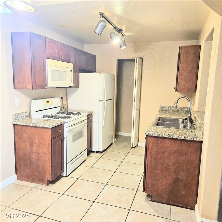 2120 Ramrod Avenue, Unit 1226 Henderson, NV 89014 - Photo 19 of 53 Kitchen featuring white appliances, track lighting, and light tile patterned floors