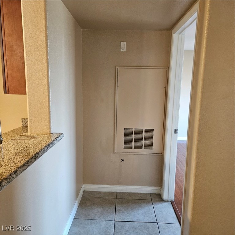2120 Ramrod Avenue, Unit 1226 Henderson, NV 89014 - Photo 24 of 53 Hallway with tile patterned floors and a textured wall